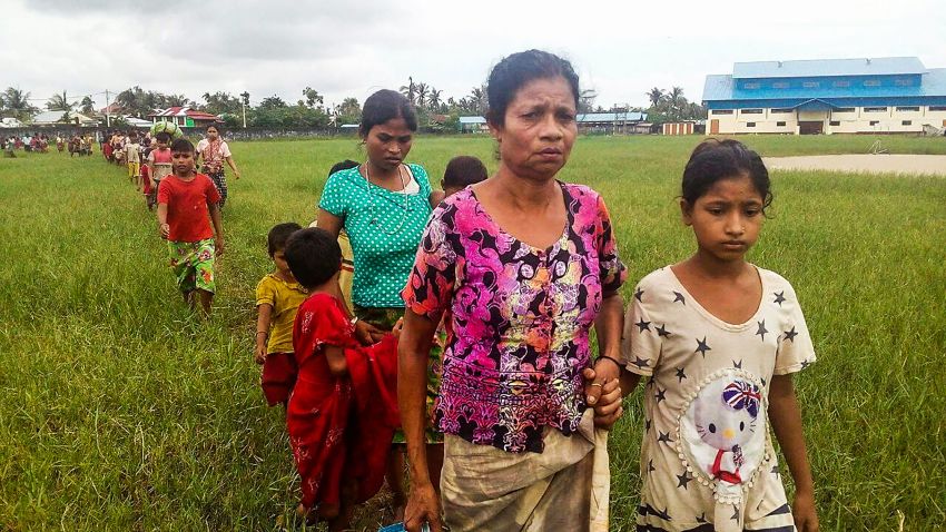 Women and children fleeing violence in their villages arrive at the Yathae Taung township in Rakhine State in Myanmar on August 26, 2017.
Terrified civilians tried to flee remote villages in Myanmar's northern Rakhine State for Bangladesh on August 26 afternoon, as clashes which have killed scores continued between suspected Rohingya militants and Myanmar security forces. / AFP PHOTO / Wai Moe        (Photo credit should read WAI MOE/AFP/Getty Images)