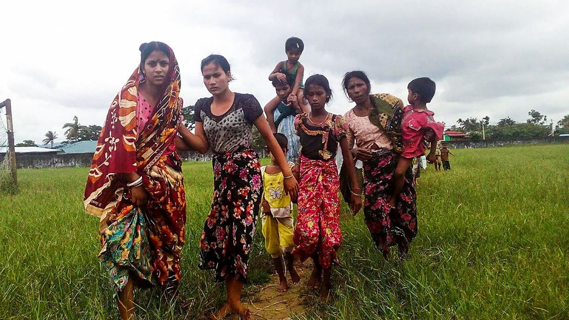 Women and children fleeing violence in their villages arrive at the Yathae Taung township in Rakhine State in Myanmar on August 26, 2017.