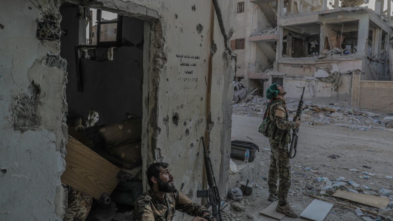 SDF forces monitor an ISIS drone hovering near the front line on Saturday. 