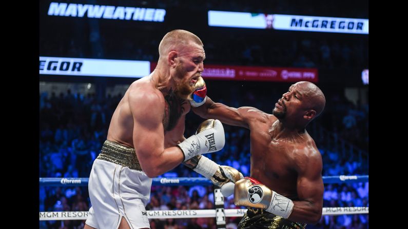 Floyd Mayweather Jr. lands a right hand against Conor McGregor during their boxing match in Las Vegas on Saturday, August 26. Mayweather stopped McGregor in the 10th round, collecting his 50th victory in what he said will be the last fight of his undefeated pro career. It was the first pro boxing match for McGregor, a mixed martial artist who is the UFC's lightweight champion. <a href="index.php?page=&url=http%3A%2F%2Fwww.cnn.com%2F2017%2F08%2F27%2Fsport%2Fgallery%2Fmayweather-mcgregor%2Findex.html" target="_blank">See more photos from the fight</a>
