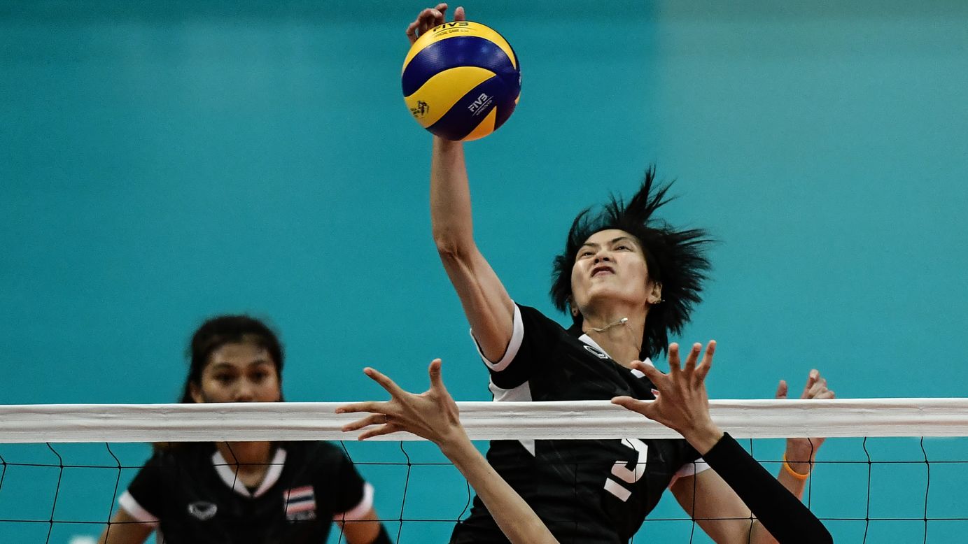 Thai volleyball player Pleumjit Thinkaow spikes the ball against the Philippines during a semifinal match at the Southeast Asian Games on Saturday, August 26. Thailand would go on to win the tournament on both the men's and the women's side.