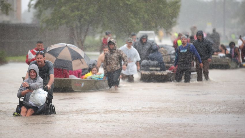 HOUSTON, TX - AUGUST 28:  People are rescued from a flooded neighborhood after it was inundated with rain water, remnants of Hurricane Harvey, on August 28, 2017 in Houston, Texas. Harvey, which made landfall north of Corpus Christi late Friday evening, is expected to dump upwards to 40 inches of rain in areas of Texas over the next couple of days.  (Photo by Scott Olson/Getty Images