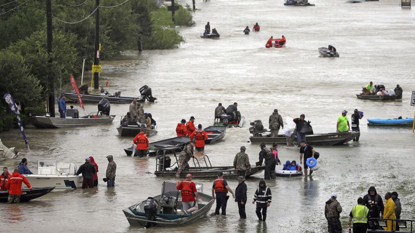 Rescue boats fill Tidwell Road as they help flood victims evacuate as floodwaters from Tropical Storm Harvey rise Monday, Aug. 28, 2017, in Houston. (AP Photo/David J. Phillip