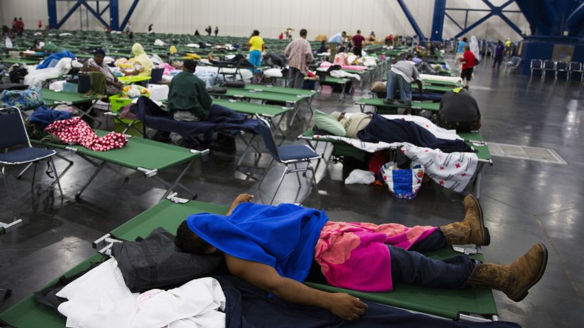 HOUSTON, TX - AUGUST 28:  Evacuees fill up cots at the George Brown Convention Center that has been turned into a shelter run by the American Red Cross to house victims of the high water from Hurricane Harvey on August 28, 2017 in Houston, Texas. Harvey, which made landfall north of Corpus Christi late Friday evening, is expected to dump upwards to 40 inches of rain in areas of Texas over the next couple of days.  (Photo by Erich Schlegel/Getty Images