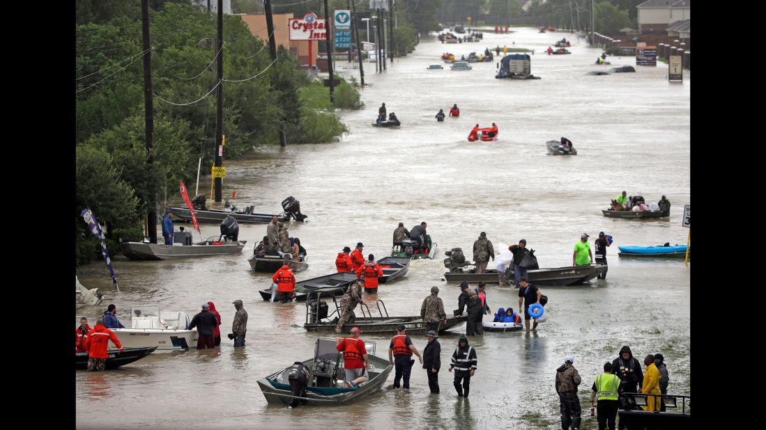 Rescue boats fill Tidwell Road in Houston as they help flood victims evacuate the area.