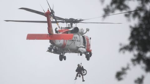 A Coast Guard helicopter hoists a wheel chair on board after lifting a person to safety from the flooded area in Houston on August 28.