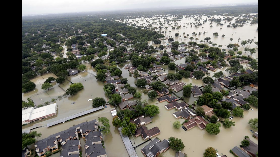 Water from the Addicks Reservoir in Houston flows into city neighborhoods on August 29.