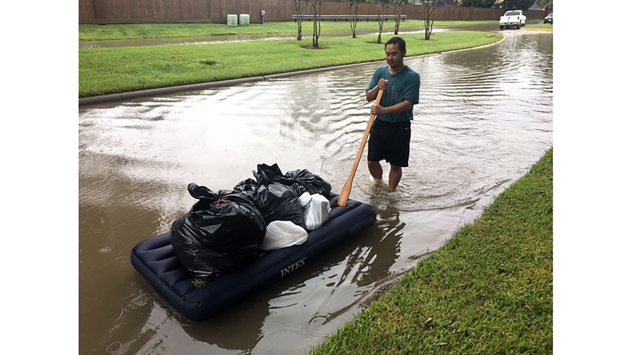 Steve Konemany pushes a mattress with belongings after the Addicks Reservoir overflowed Tuesday.