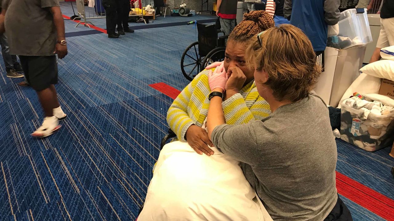 Harvey evacuee Karen Preston cries as she is given a pillow at Houston's convention center.