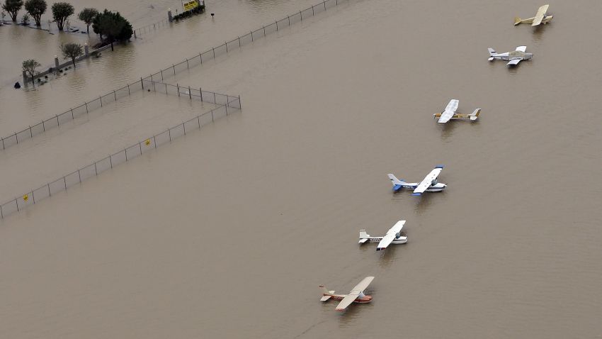 Airplanes sit at a flooded airport near the Addicks Reservoir as floodwaters from Tropical Storm Harvey rise Tuesday, Aug. 29, 2017, in Houston. (AP Photo/David J. Phillip)