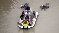 Evacuees make their way though floodwaters near the Addicks Reservoir as floodwaters from Tropical Storm Harvey rise Tuesday, Aug. 29, 2017, in Houston. (AP Photo/David J. Phillip)