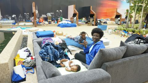 Gladys Dasi watches her 2-month-old son and 8-year-old daughter relax.