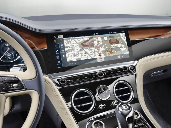 This Retina-resolution screen actually has three sides, so it can show analogue dials or a panel that matches the dashboard's wood veneers. 