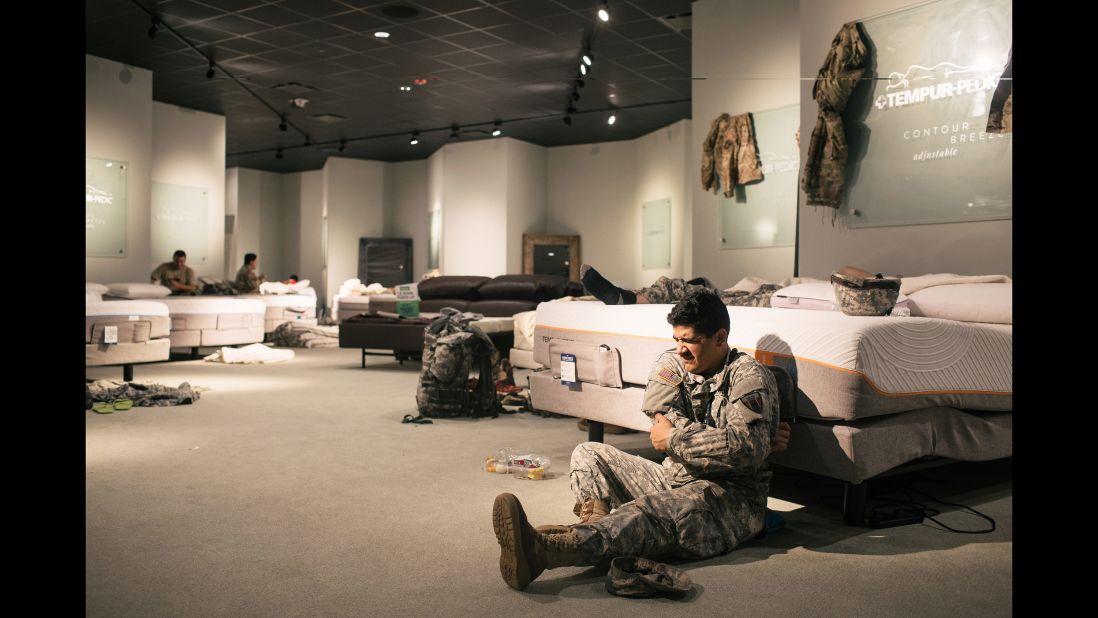 Members of the National Guard rest at a furniture store in Richmond, Texas.