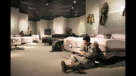 Members of the National Guard rest at a furniture store in Richmond, Texas.