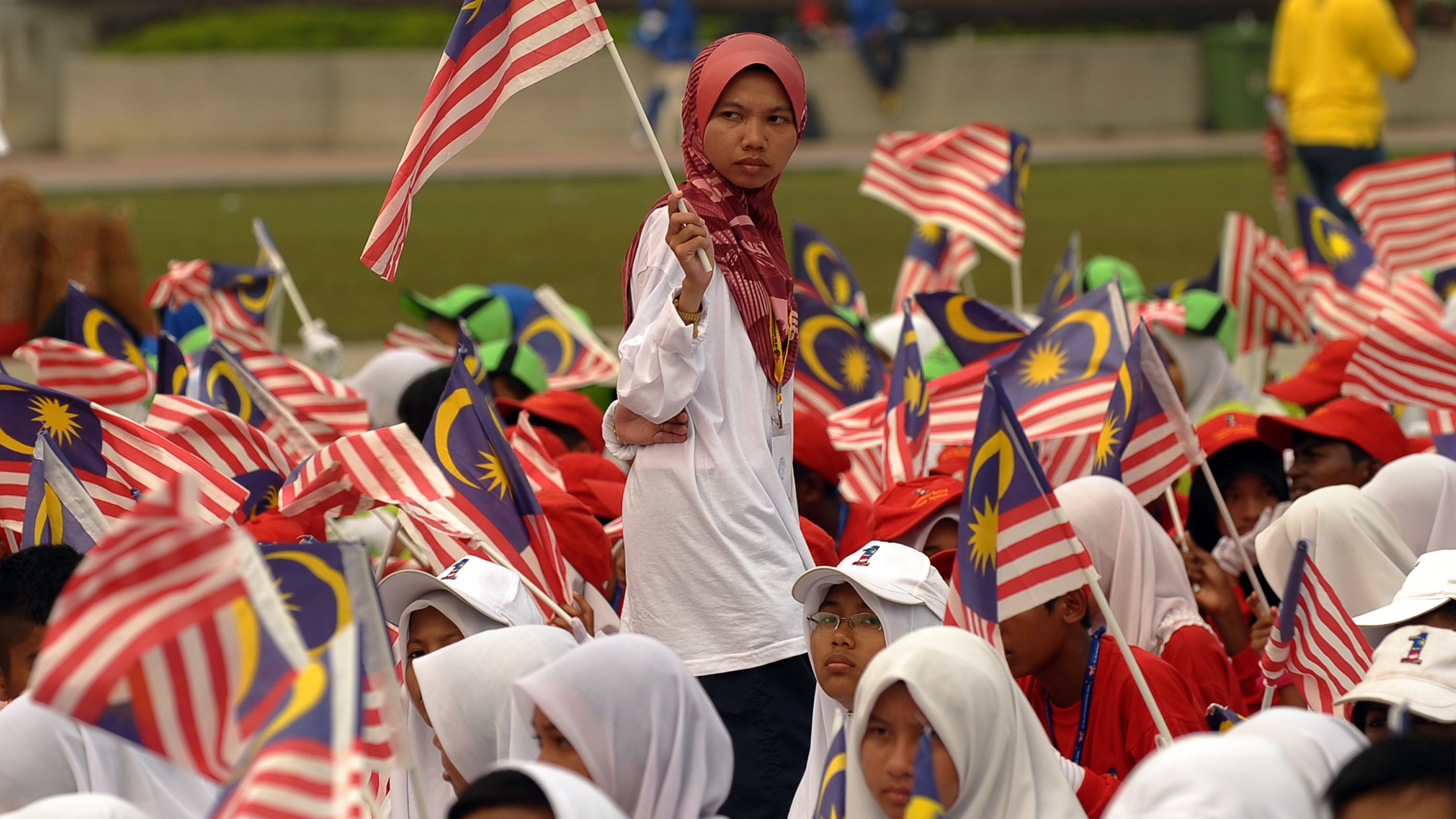 A Malaysian girl carries a national flag during an Independence Day parade rehearsals in Kuala Lumpur. 