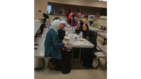 Evacuees eat at the Brand Lane Islamic Center in Stafford, Texas.
