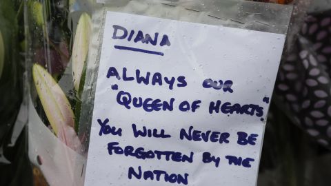 A tribute is attatched to the gates of Kensington Palace in London on Wednesday. 
