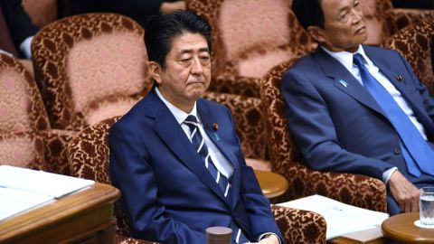 Japan's Prime Minister Shinzo Abe (left) and Deputy Prime Minister Taro Aso (right) attend a budget dommittee meeting in parliament on July 25.
