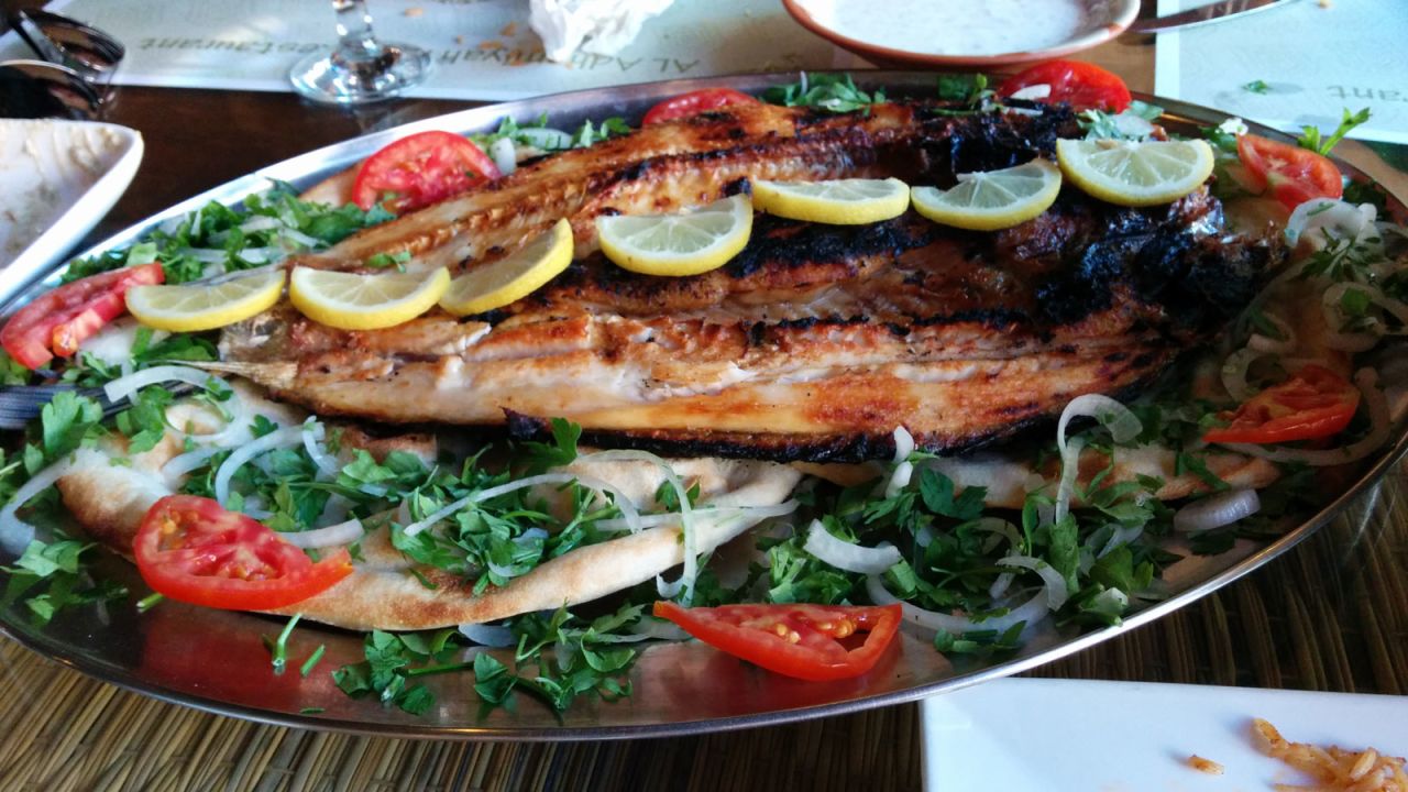 <strong>Iraqi masgouf: </strong> Grilled carp slow-cooked for up to three hours and served with lemon and pickles is considered by many to be the national dish of Iraq.