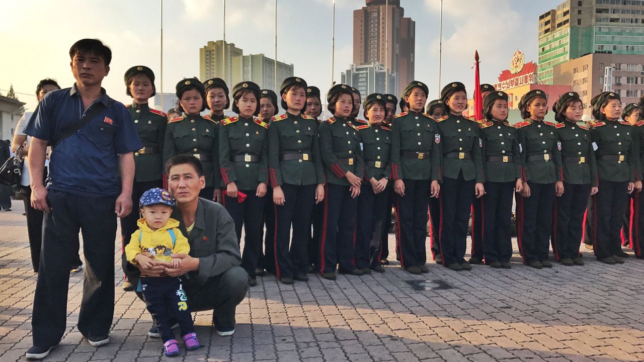 North Koreans watch news of the country's latest missile test be announced in Pyongyang on August 30.