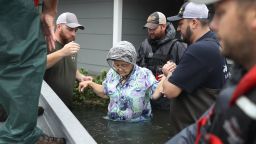 PORT ARTHUR, TX - AUGUST 30:  Volunteer rescuer workers help a woman from her home that was inundated with the flooding of Hurricane Harvey on August 30, 2017 in Port Arthur, Texas. Harvey, which made landfall north of Corpus Christi late Friday evening, is expected to dump upwards to 40 inches of rain in Texas over the next couple of days.  (Photo by Joe Raedle/Getty Images)