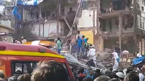 Bystanders rush to the scene of the collapse Thursday morning.