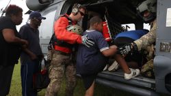 Tthe Florida Air Force Reserve Para-Rescue team from the 308th Rescue Squadron helps evacuees board a helicopter in Port Arthur on August 30.