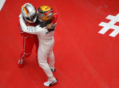 Hamilton and Sebastian Vettel embrace at the 2017 Chinese Grand Prix. The season looked set to go down to the wire until Hamilton stormed to five wins in six races during August, September and October, ending Vettel and Ferrari's hopes of glory. 