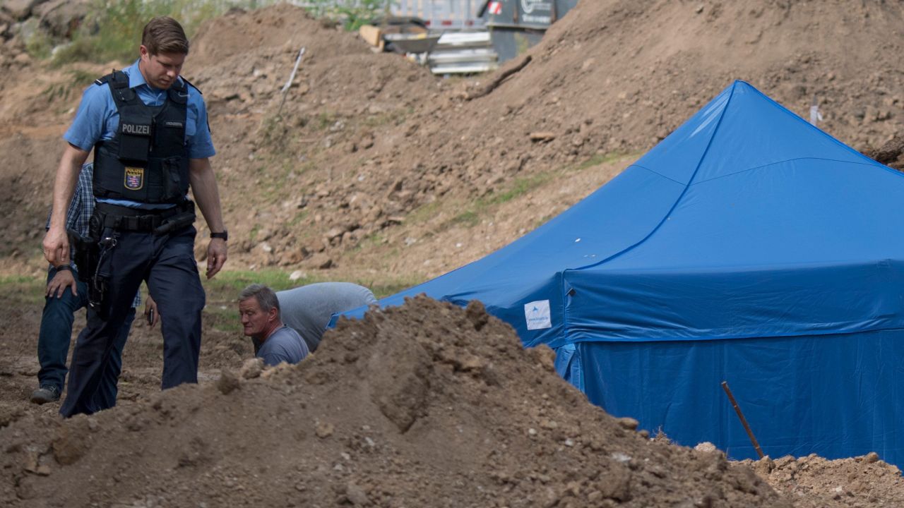 A policeman walks past a blue tent covering a British World War II bomb that was found during construction works on August 30, 2017 in Frankfurt am Main, western Germany.
The disposal of the bomb that is planned for Sunday, September 3, 2017 requires the evacuation of around 70,000 people. / AFP PHOTO / dpa / Boris Roessler / Germany OUT        (Photo credit should read BORIS ROESSLER/AFP/Getty Images)