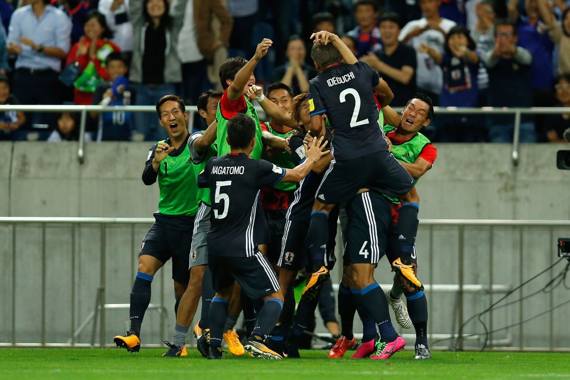 Yosuke Ideguchi celebrates scoring his side's second goal with his teammates in the 2-0 World Cup win over Australia.