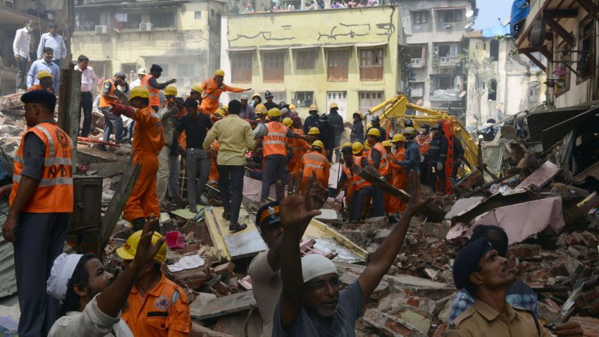 Rescue workers and residents look for survivors at the site of a building collapse in Mumbai on August 31, 2017.
At least three people died and dozens were feared trapped when a building collapsed in India's financial capital of Mumbai on August 31, after days of heavy rain swamped the city. / AFP PHOTO / PUNIT PARANJPE        (Photo credit should read PUNIT PARANJPE/AFP/Getty Images)
