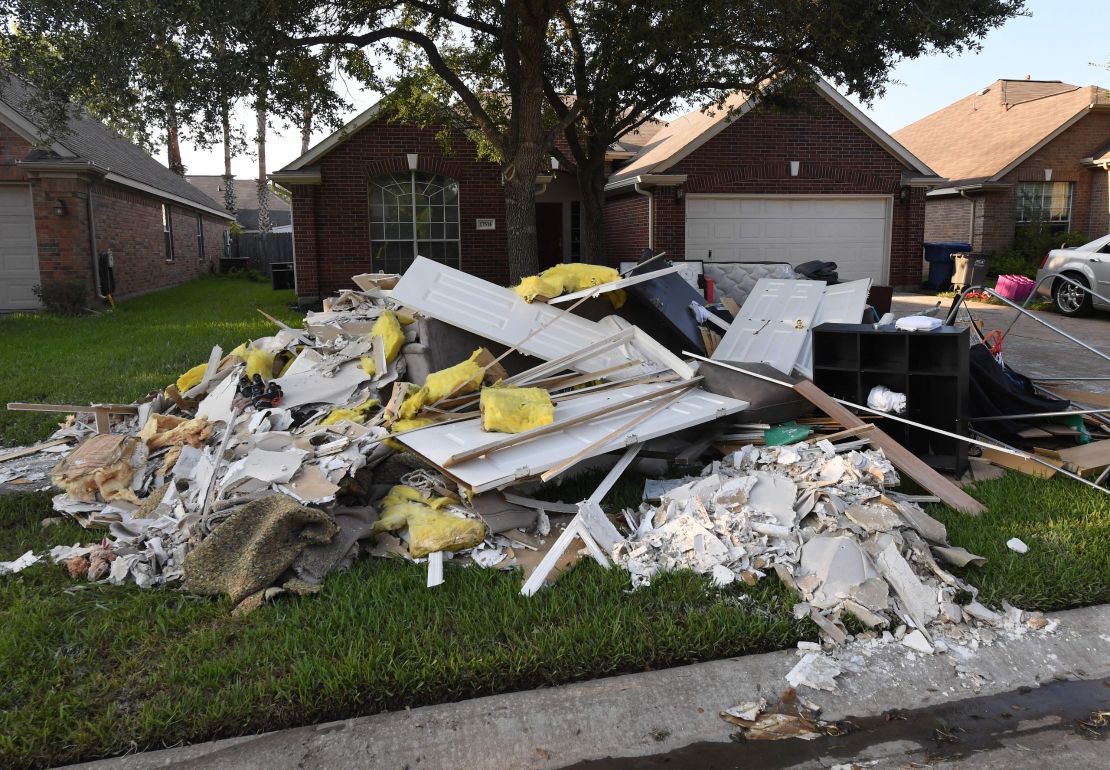 Debris sits on a sidwalk Thursday outside a home in Houston.