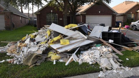 Debris sits on a sidewalk  Thursday in the Twin Oaks Estate neighborhood of Houston.