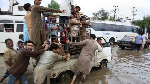 People push a vehicle after heavy rainfall in Karachi, Pakistan, Thursday, Aug. 31, 2017.