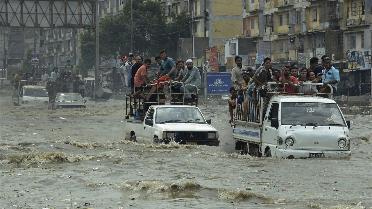 Pakistani commuters travel on a flooded street following a heavy rainfall in Karachi, Pakistan, Thursday, Aug. 31, 2017.