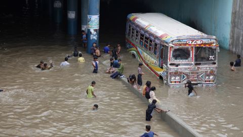 Pakistani children play in an underpass filled with rainwater in Karachi, Pakistan, Thursday, Aug. 31, 2017.
