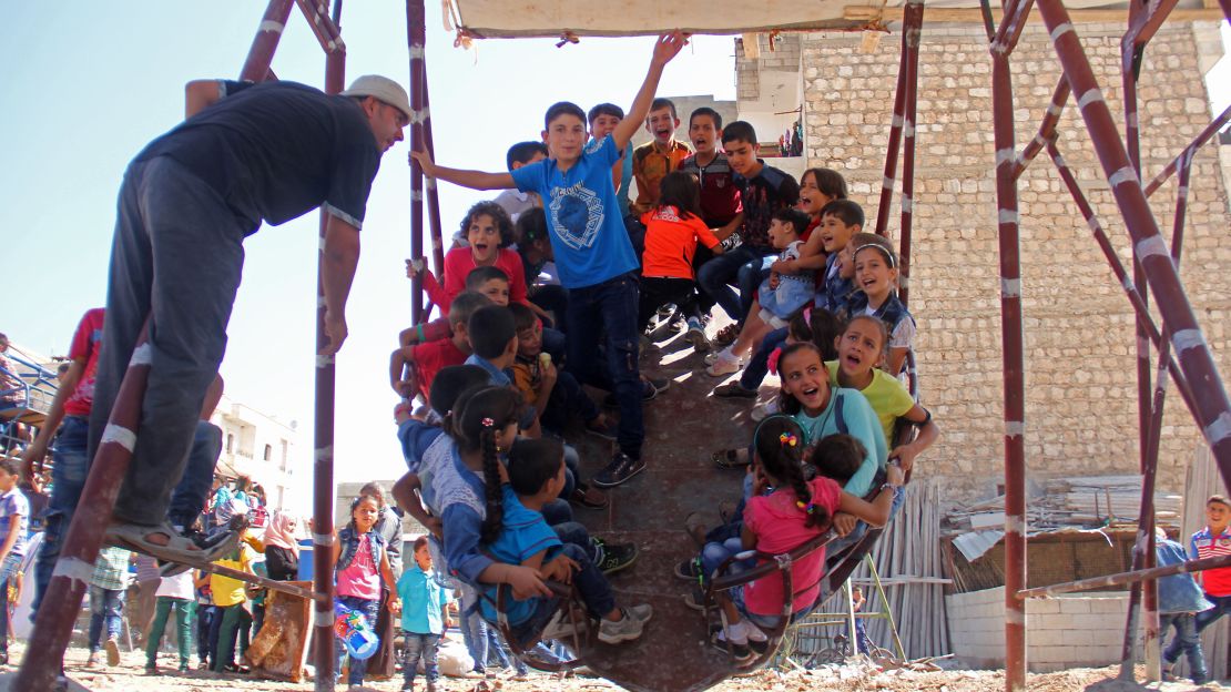 Syrian children ride an attraction in the northwest Syrian city of Idlib.