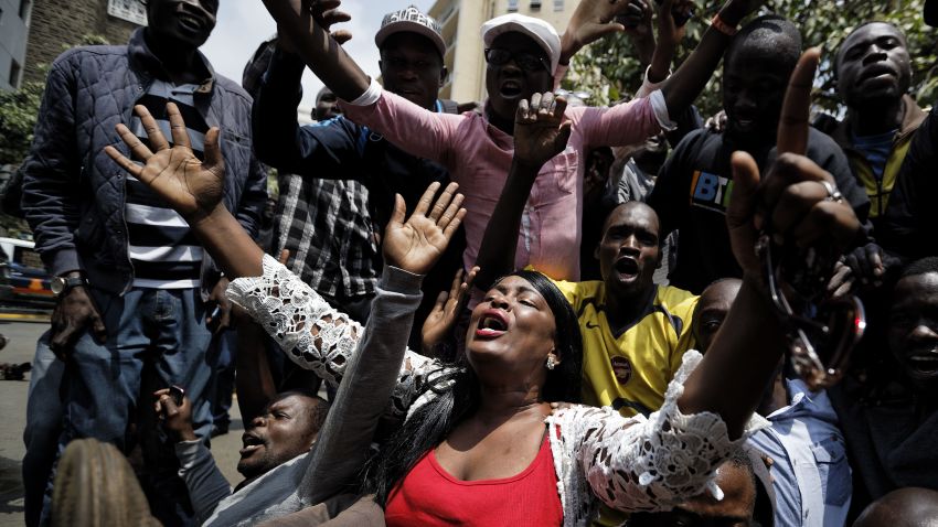 Supporters of opposition leader Raila Odinga kneel down and thank God as they celebrate after hearing the verdict, on a street opposite the Supreme Court in downtown Nairobi, Kenya Friday, Sept. 1, 2017. Kenya's Supreme Court on Friday nullified President Uhuru Kenyatta's election win last month and called for new elections within 60 days, shocking a country that had been braced for further protests by opposition supporters. (AP Photo/Ben Curtis)