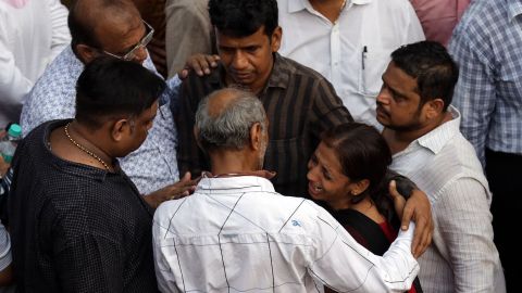 A woman cries as she watches the rescue operation.