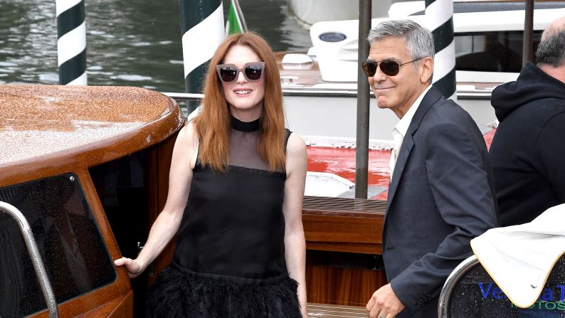 George Clooney and Julianne Moore arrive by boat, in true Venetian style, for a photo call. 