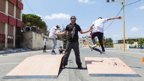 Children perform tricks on skateboards at the SkateQilya summer camp in the West Bank town of Qalqilya.
