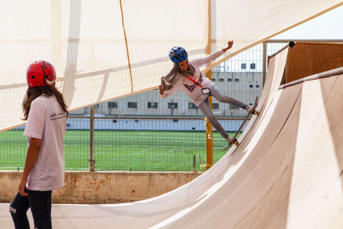 A young skateboarder takes on the ramp at the SkateQilya camp in the West Bank.