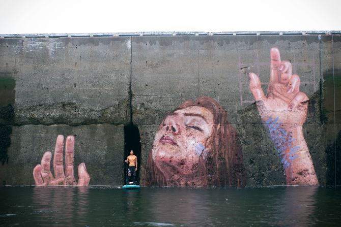 Surfer and artist Sean Yoro has created a mural in a spot -- Canada's Bay of Fundy -- where the tides submerge the work in less than 6 hours every day. 