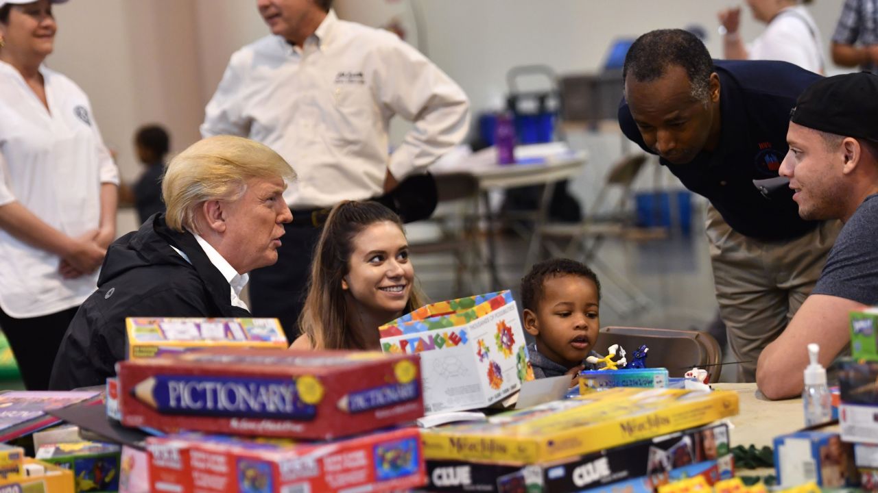 President Donald Trump, with Secretary of Housing and Urban Development Ben Carson, visits Hurricane Harvey victims at NRG Center in Houston on September 2.