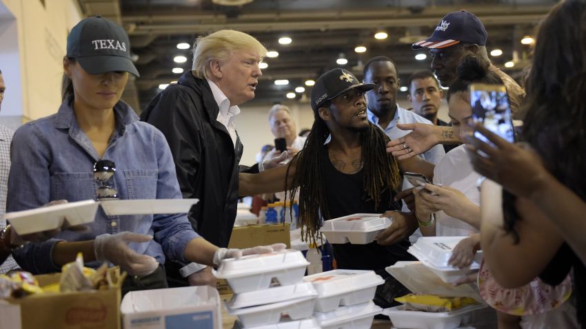 President Donald Trump and Melania Trump pass out food and meet people impacted by Hurricane Harvey during a visit to the NRG Center in Houston on September 2, 2017.
