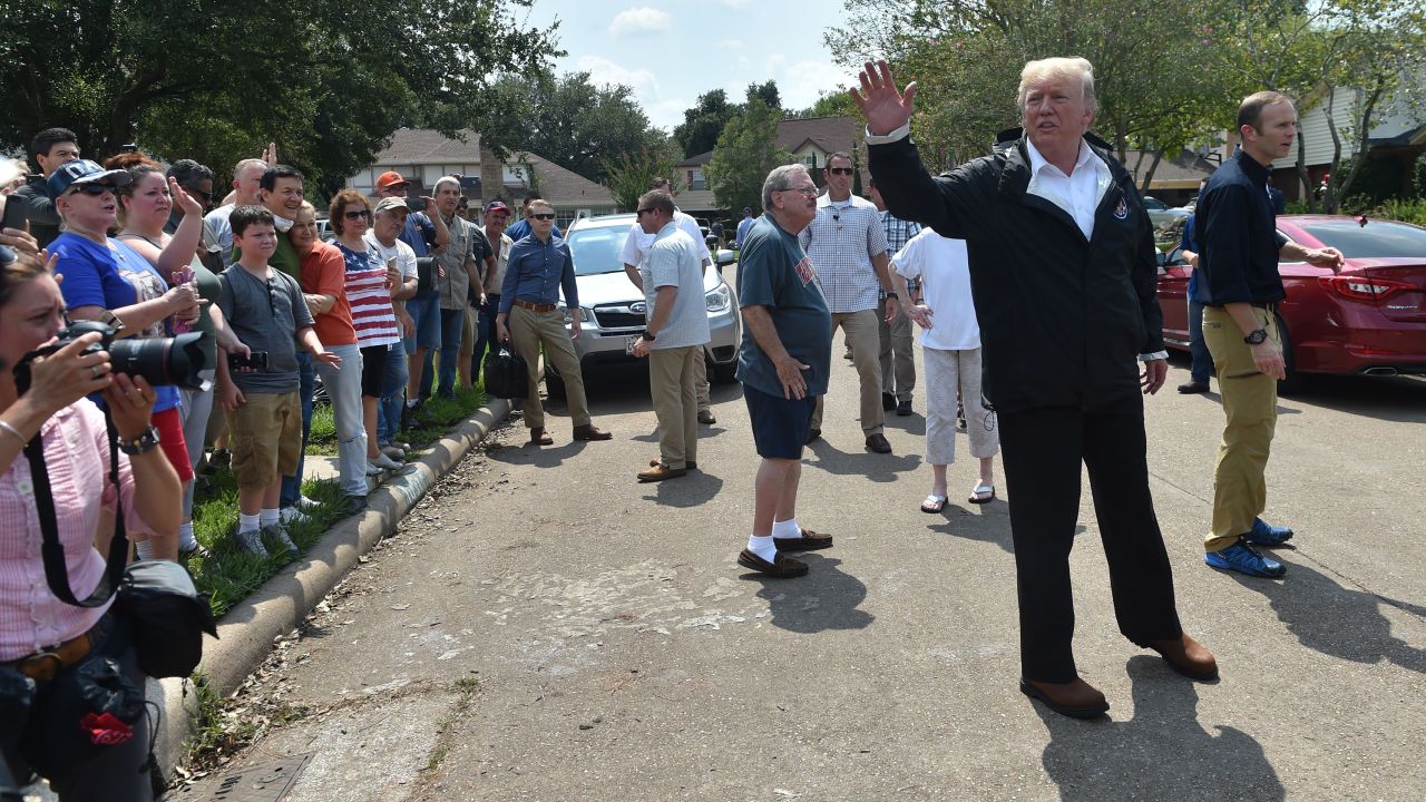 President Donald Trump visit a neighborhood in Houston while touring areas affected by Hurricane Harvey on September 2.