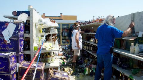 The walls are gone, but some stock was still on the shelves of a liquor store.