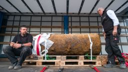 Dieter Schwetzler (R) and Rene Bennert (L) of the Explosive Ordnance Disposal Division pose next to the World War II bomb they defused in Frankfurt am Main, Germany, on September 03, 2017. 
More than 60,000 people was evacuated from the center of Frankfurt on Sunday after a 1.4-ton World War II bomb (HC 4000 air mine) was discovered on a construction site close to the Goethe University Frankfurt compound last Tuesday.  / AFP PHOTO / Thomas Lohnes        (Photo credit should read THOMAS LOHNES/AFP/Getty Images)