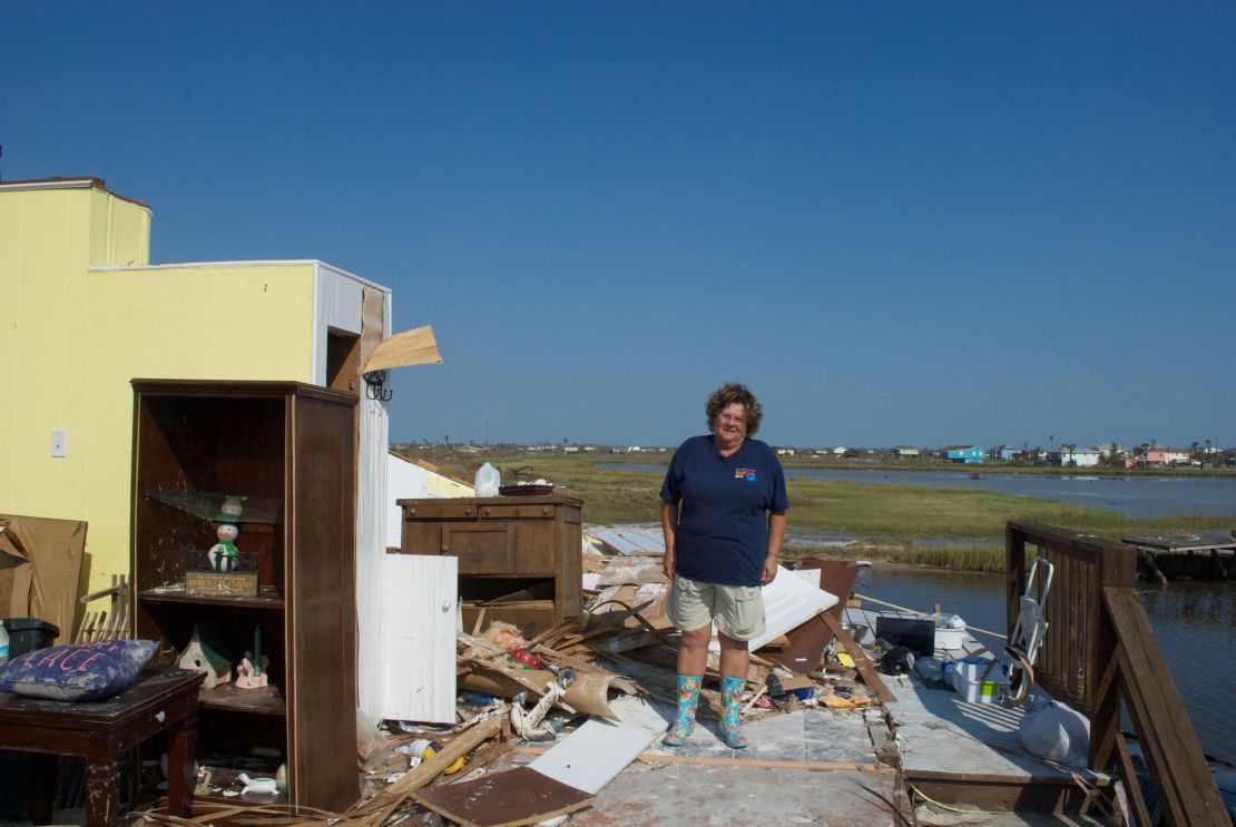 Peggy Bourg stand on the second floor of her ruined home in Holiday Beach.